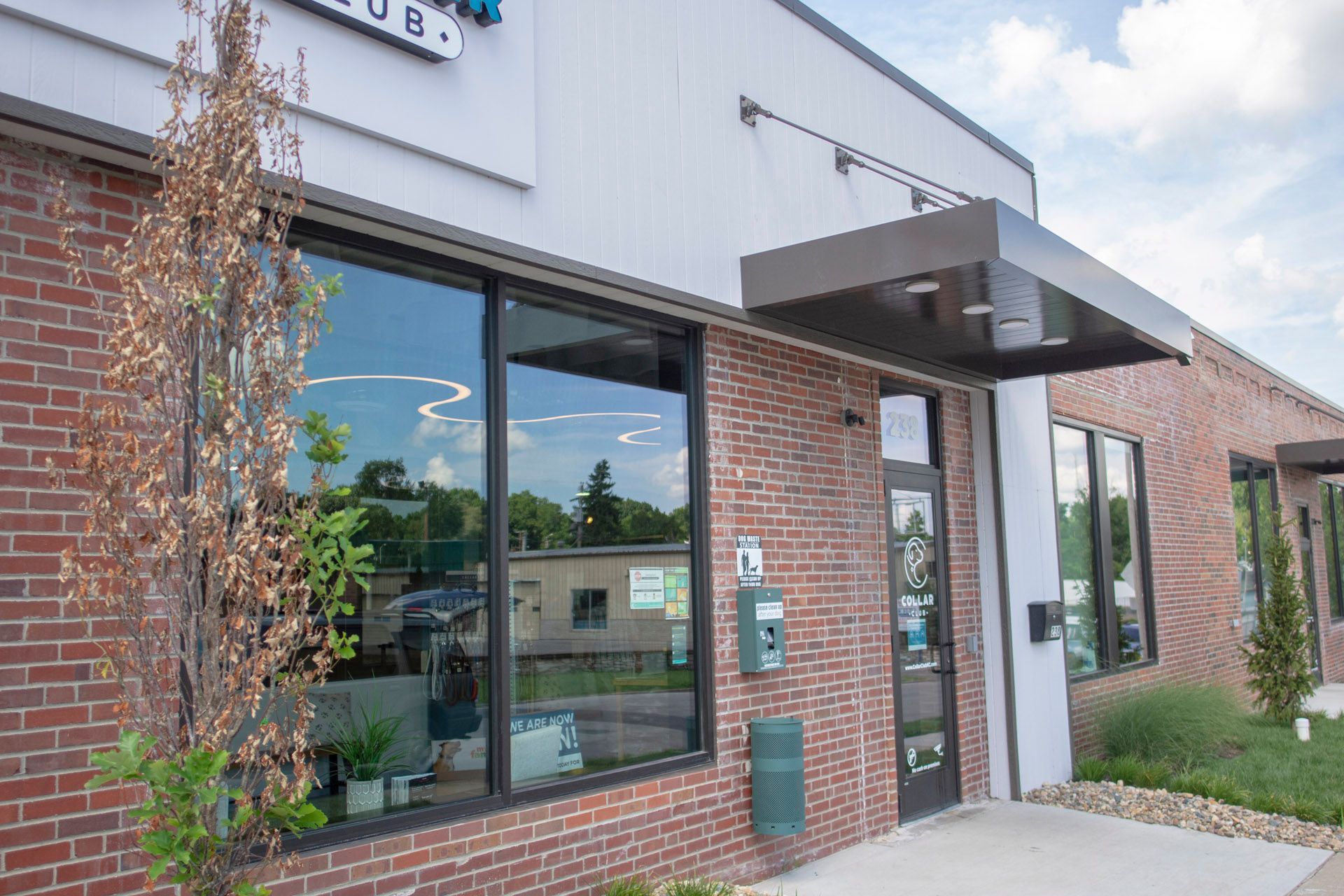 The front of a brick building with a canopy over the entrance.