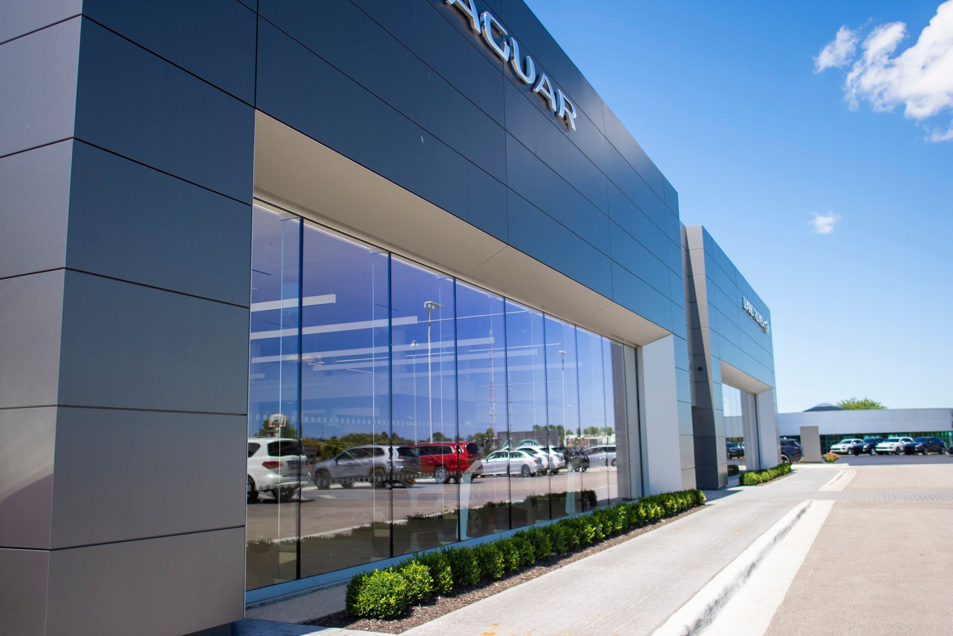 A jaguar car dealership with a lot of windows