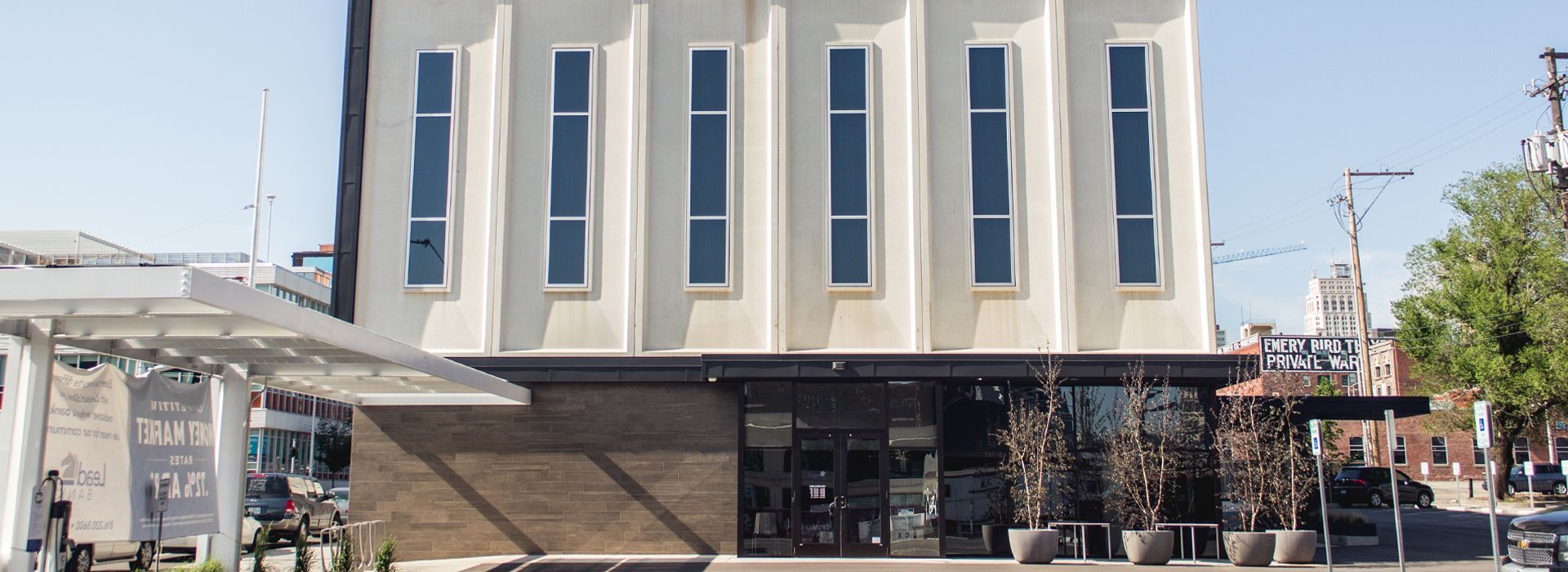 A large white building with a lot of windows on a sunny day.