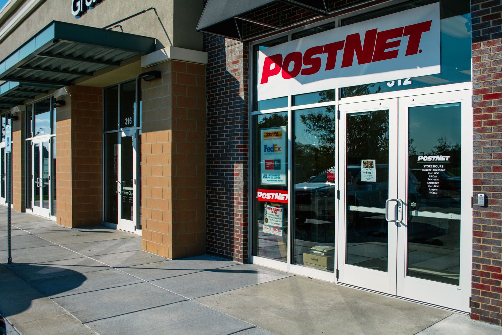 A postnet store is located in a brick building