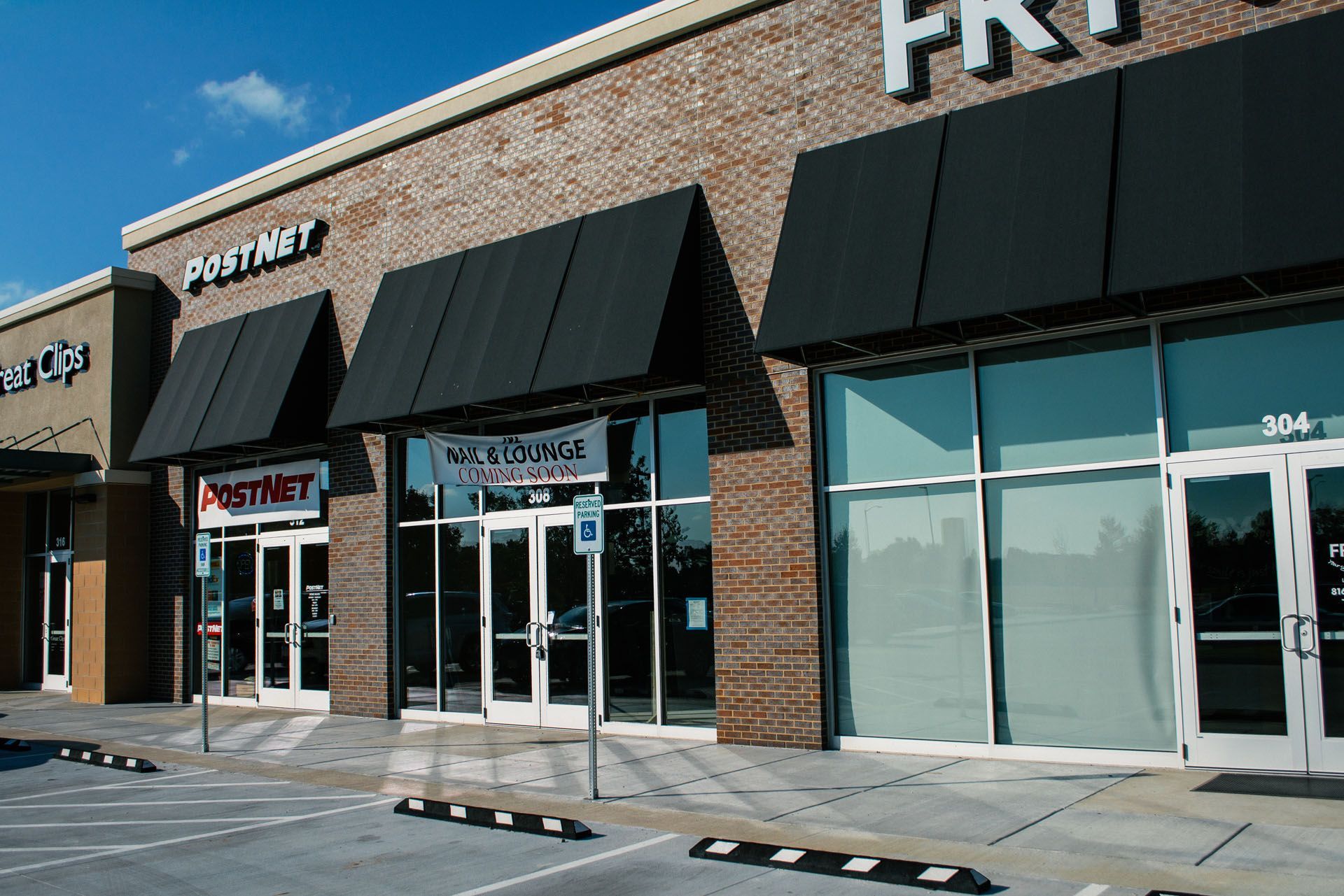 A brick building with black awnings and a sign that says fastnet