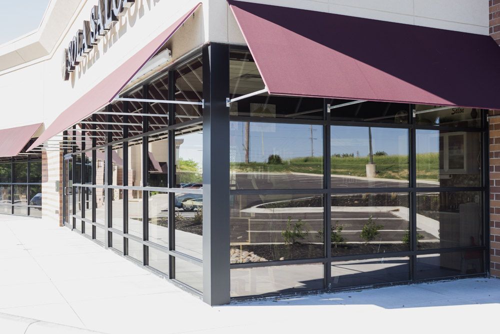 A store front with a purple awning on it