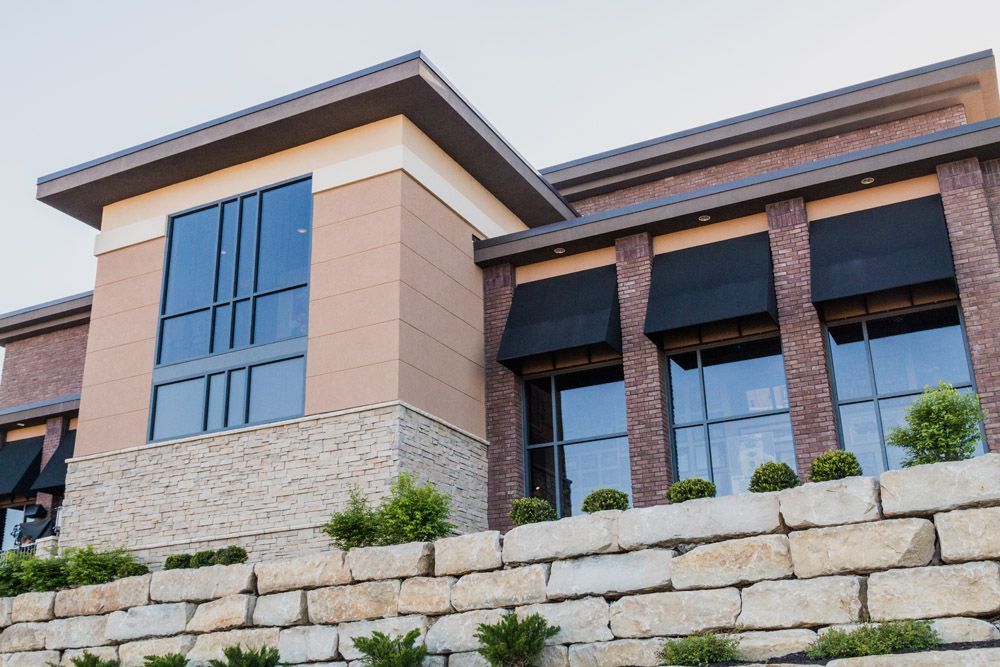 A large brick building with lots of windows and awnings
