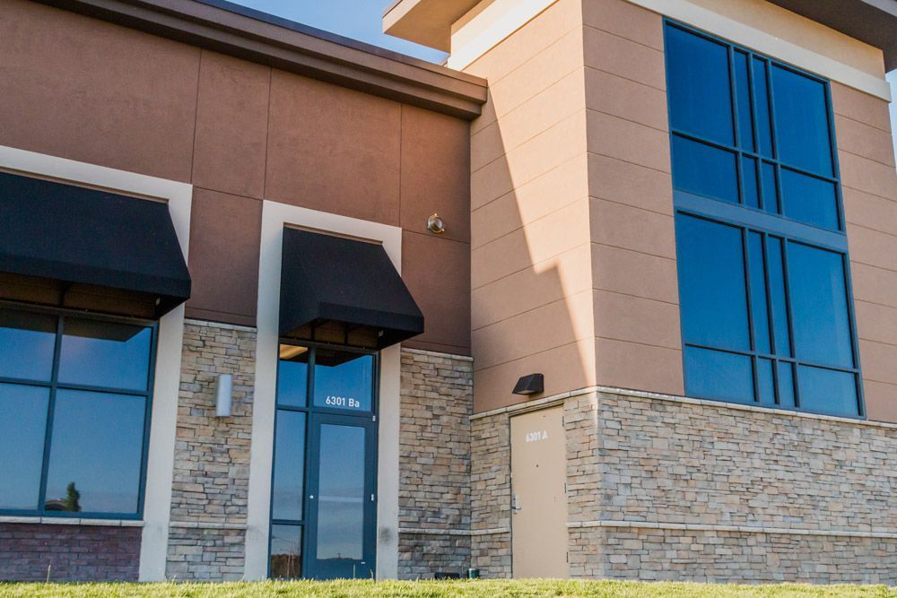A building with a lot of windows and a black awning