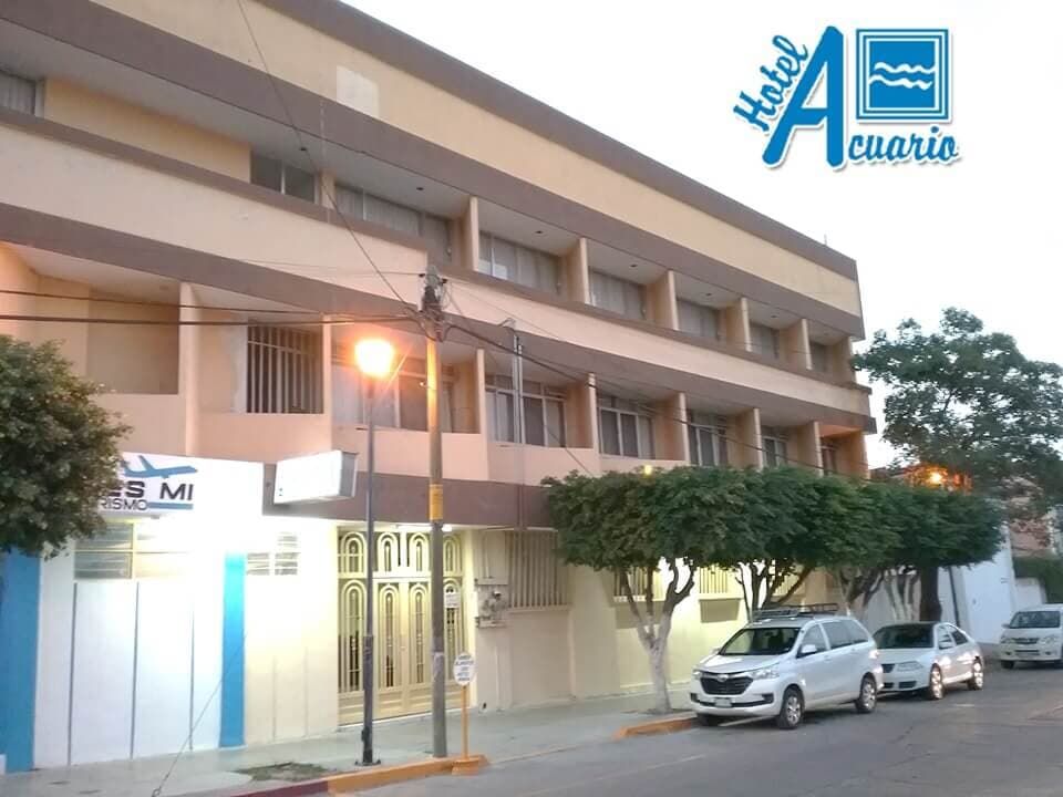 Un hotel con coches aparcados delante.