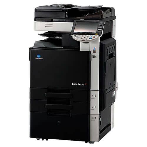 Una impresora en blanco y negro está colocada encima de una mesa blanca.