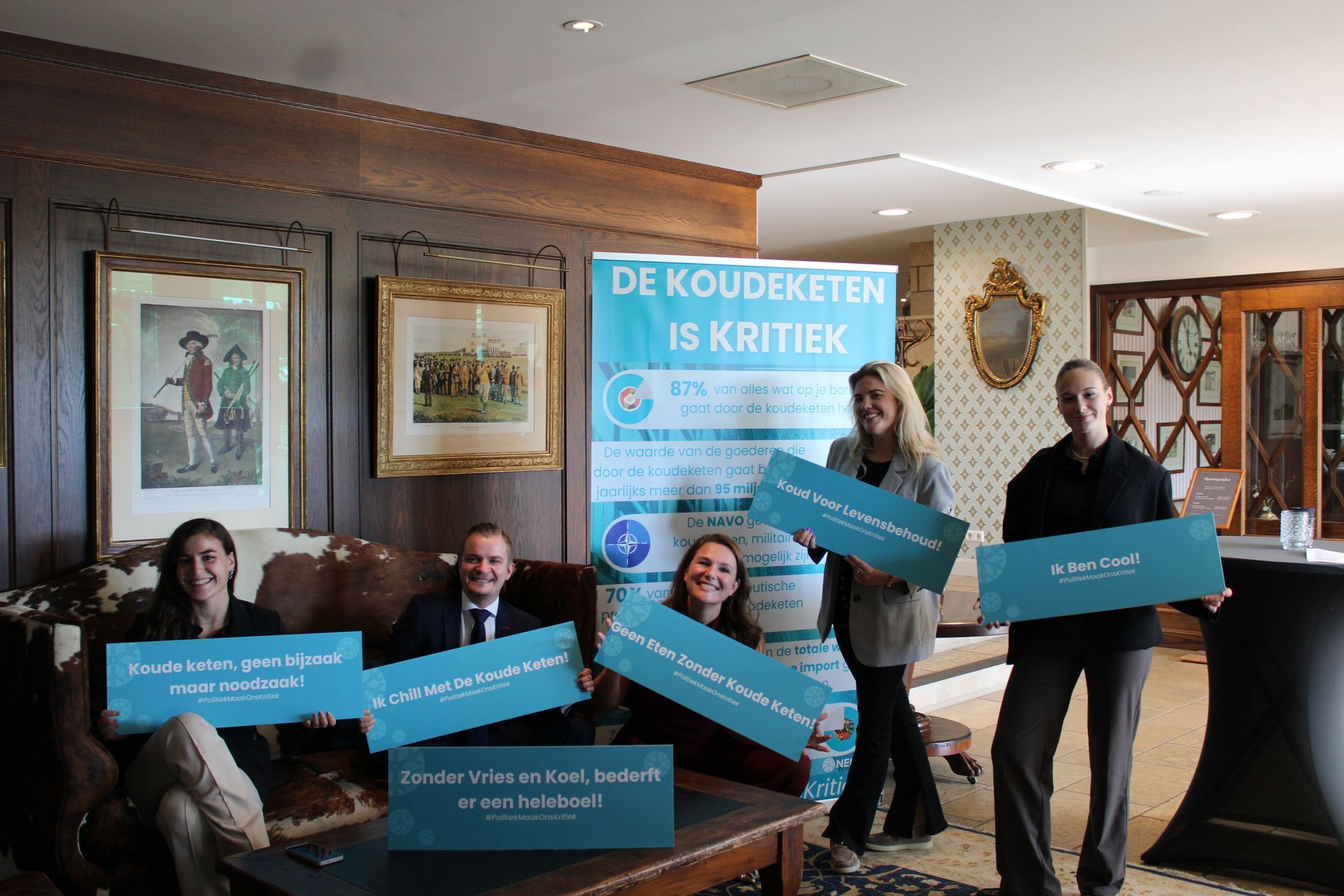 Een groep mensen zit in een kamer met een bord waarop staat kickstart