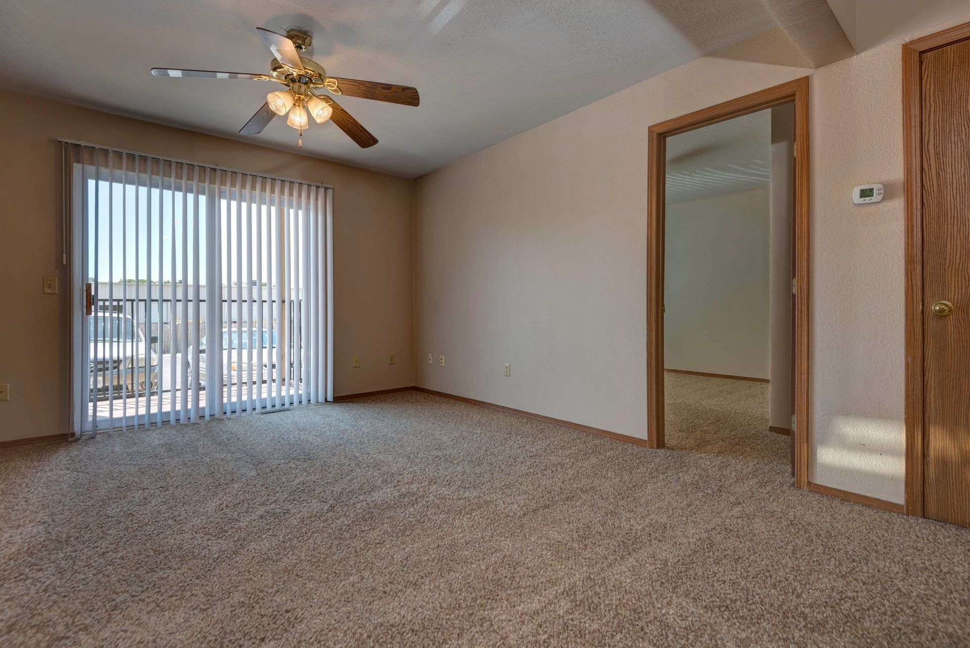 Photo of a large living room with an exit to a patio in the background