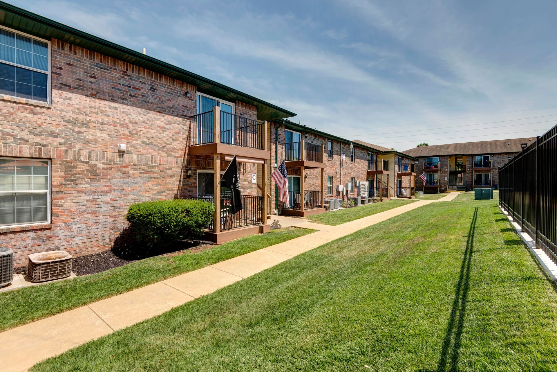 Photo of the exterior courtyard area between a building and a pool