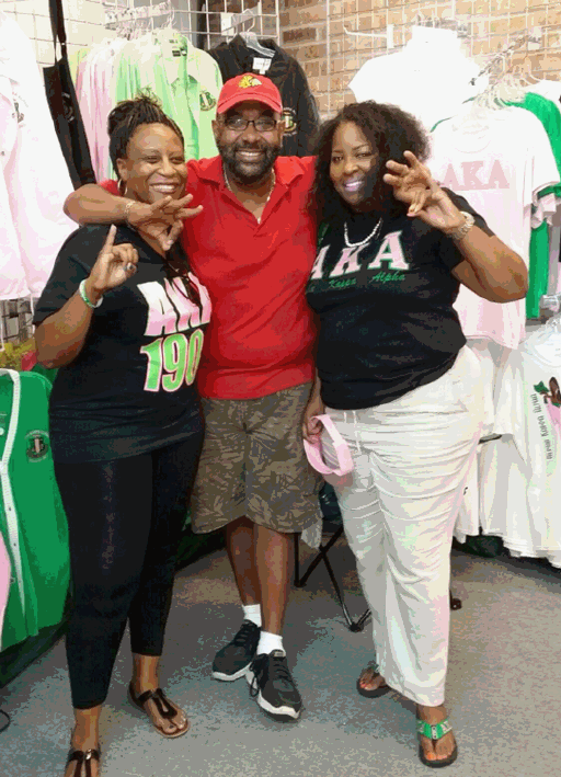 A man and two women are posing for a picture in a store.