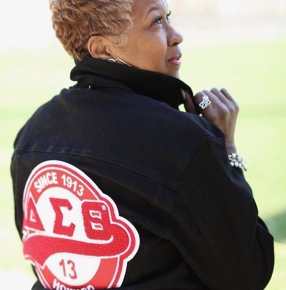 A woman wearing a black jacket that says since 1913