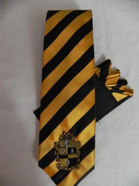 A yellow and black striped tie with a crest on it