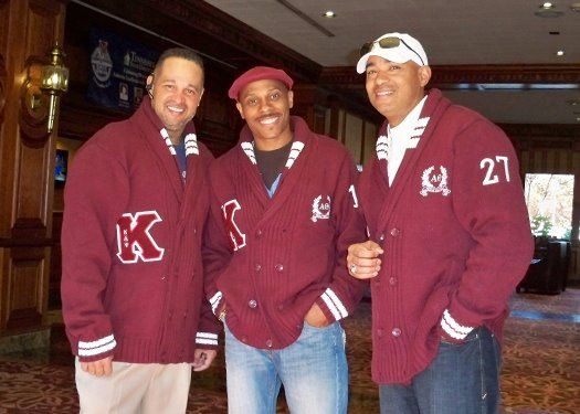 Three men wearing maroon jackets with the letter k on them