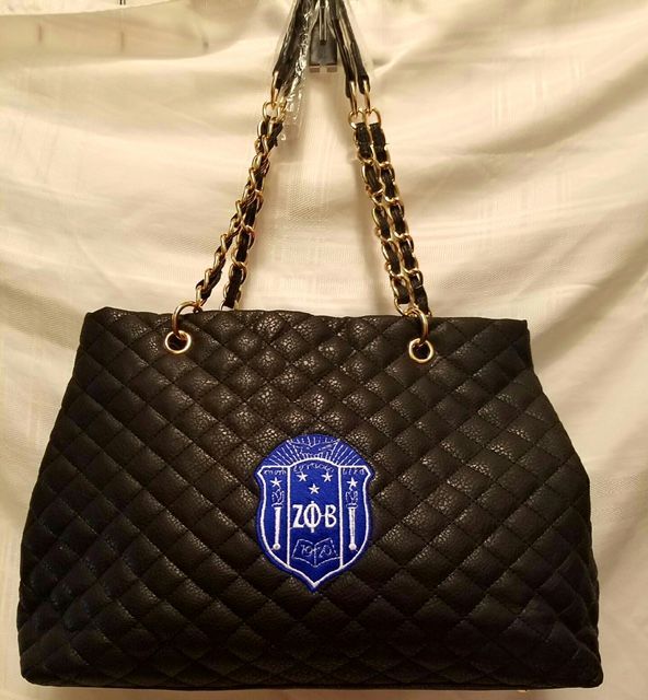 A black purse with a blue emblem that says zobi