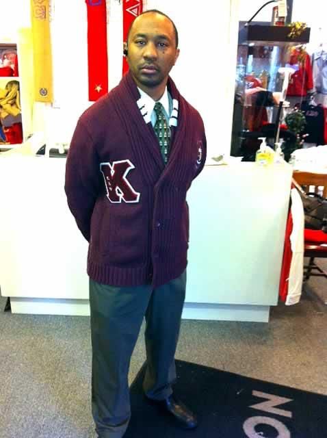 A man wearing a sweater with the letter k on it