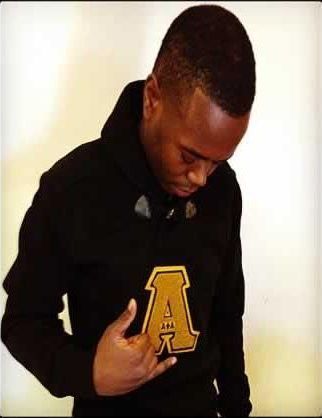 A man wearing a black hoodie with the letter a on it.
