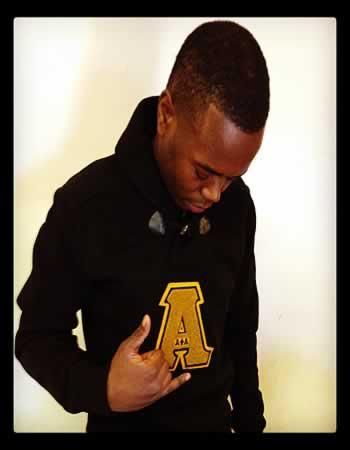 A man wearing a black hoodie with the letter a on it