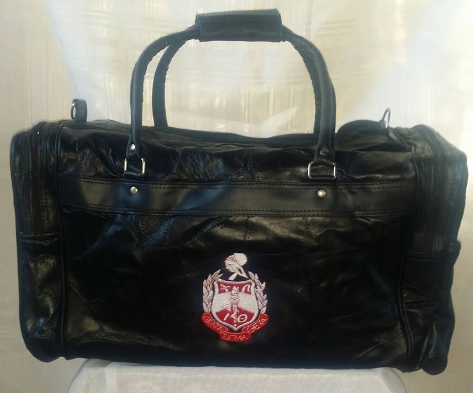 A black duffel bag with a crest on it