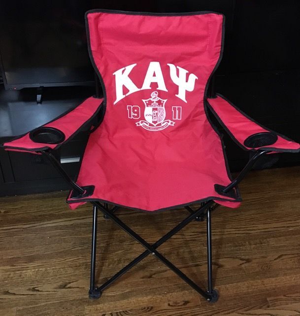 A red folding chair with the word kay on it
