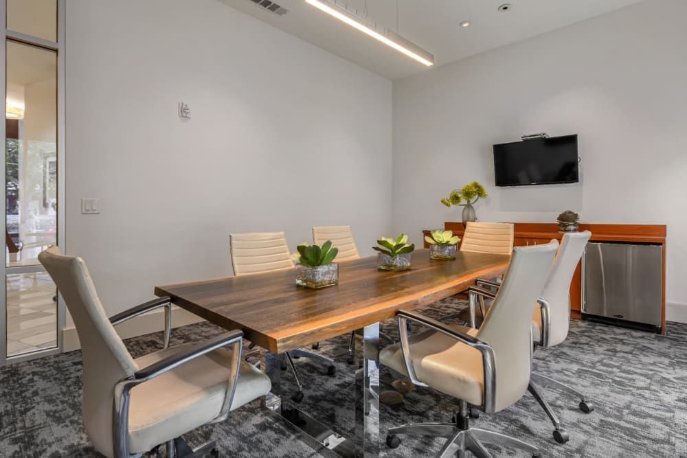 Apartment community conference room with meeting table and chairs at Sabina in Austin, TX.