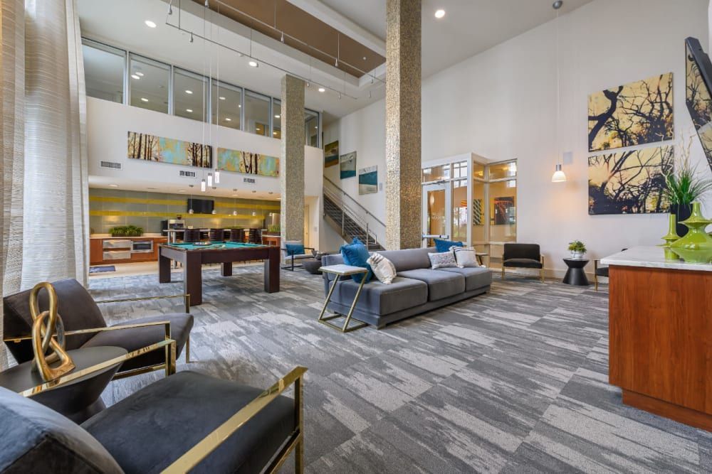 Two-floor clubhouse with a pool table in the middle of the room at Sabina in Austin, TX.