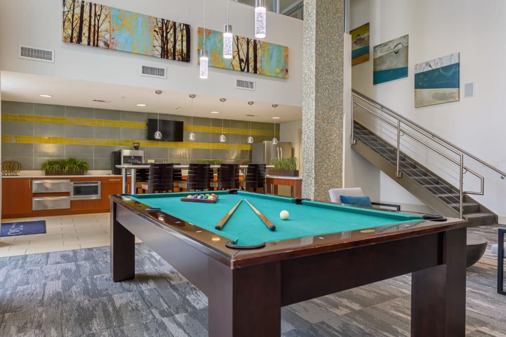 Clubhouse entertainment lounge with a pool table in the middle of the room at Sabina in Austin, TX.