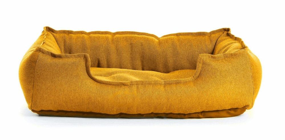 A yellow dog bed on a white background