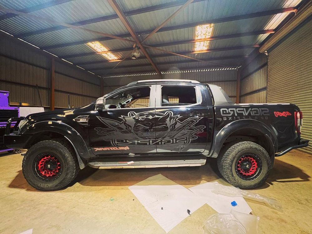 A Black Vehicle With Vehicle Wrap - Car Signwriting in Wagga Wagga, NSW