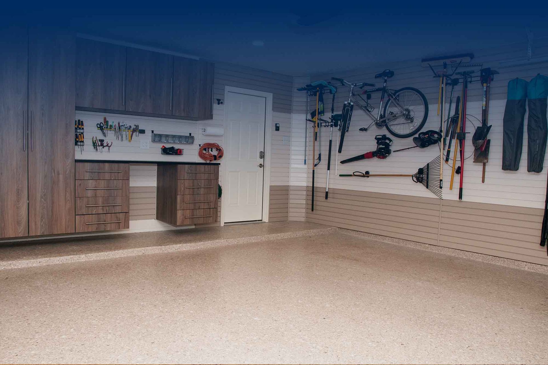 Garagewerx epoxy garage flooring with slatwall panels and cabinets