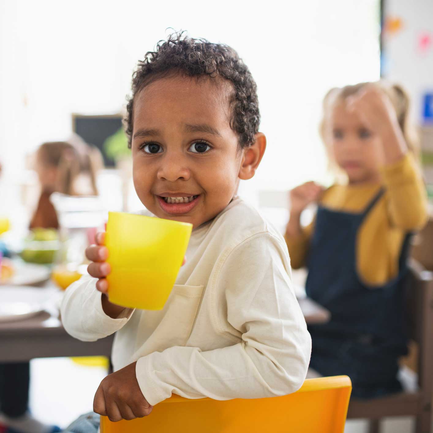 Little kid holding a cup — Richfield, NC — Richfield Child Development Center