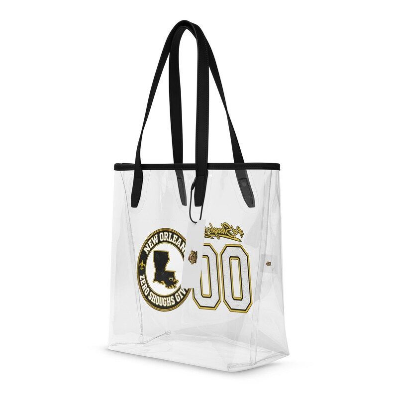 Clear plastic tote bag with black handles and a gold and black New Orleans graphic featuring the state of Louisiana.