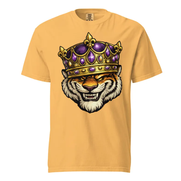 A gold-colored t-shirt with a graphic illustration of a snarling tiger wearing a purple and gold crown.