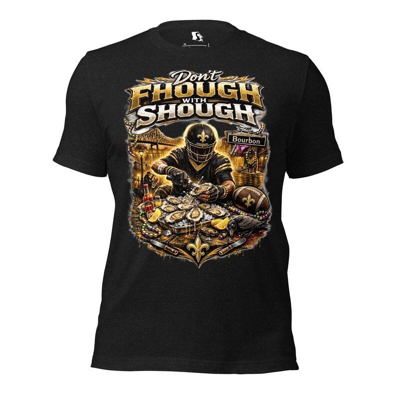 Black T-shirt featuring a football player in gold and black gear shucking oysters with New Orleans-themed imagery.