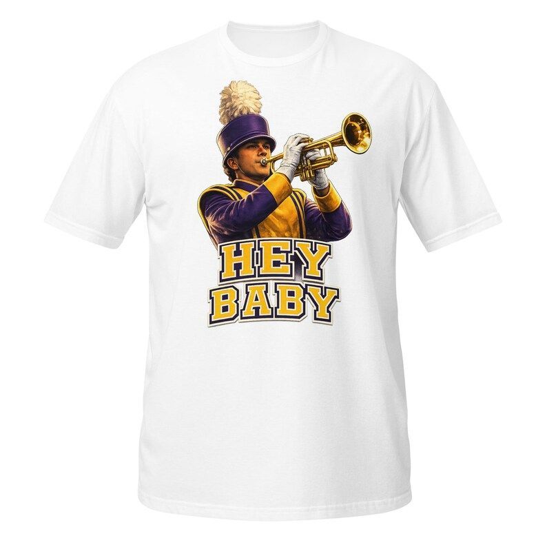 Trumpet player in a purple and gold band uniform, playing with