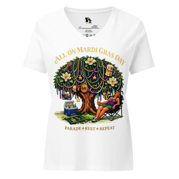 A white v-neck t-shirt featuring a tree decorated with Mardi Gras beads, a person resting in a chair, and festive text.