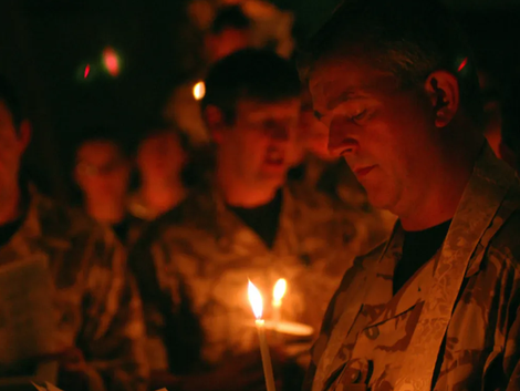 Image of the Rev. Timothy A. R. Cole candlelight service with soldiers 