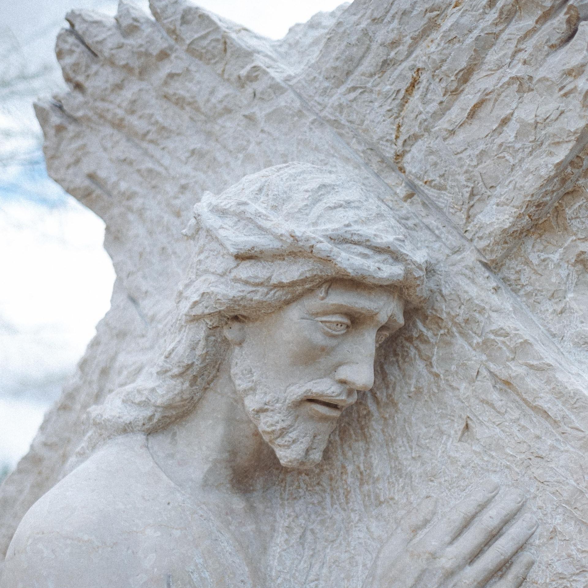 A stone carving of Jesus carrying the cross 