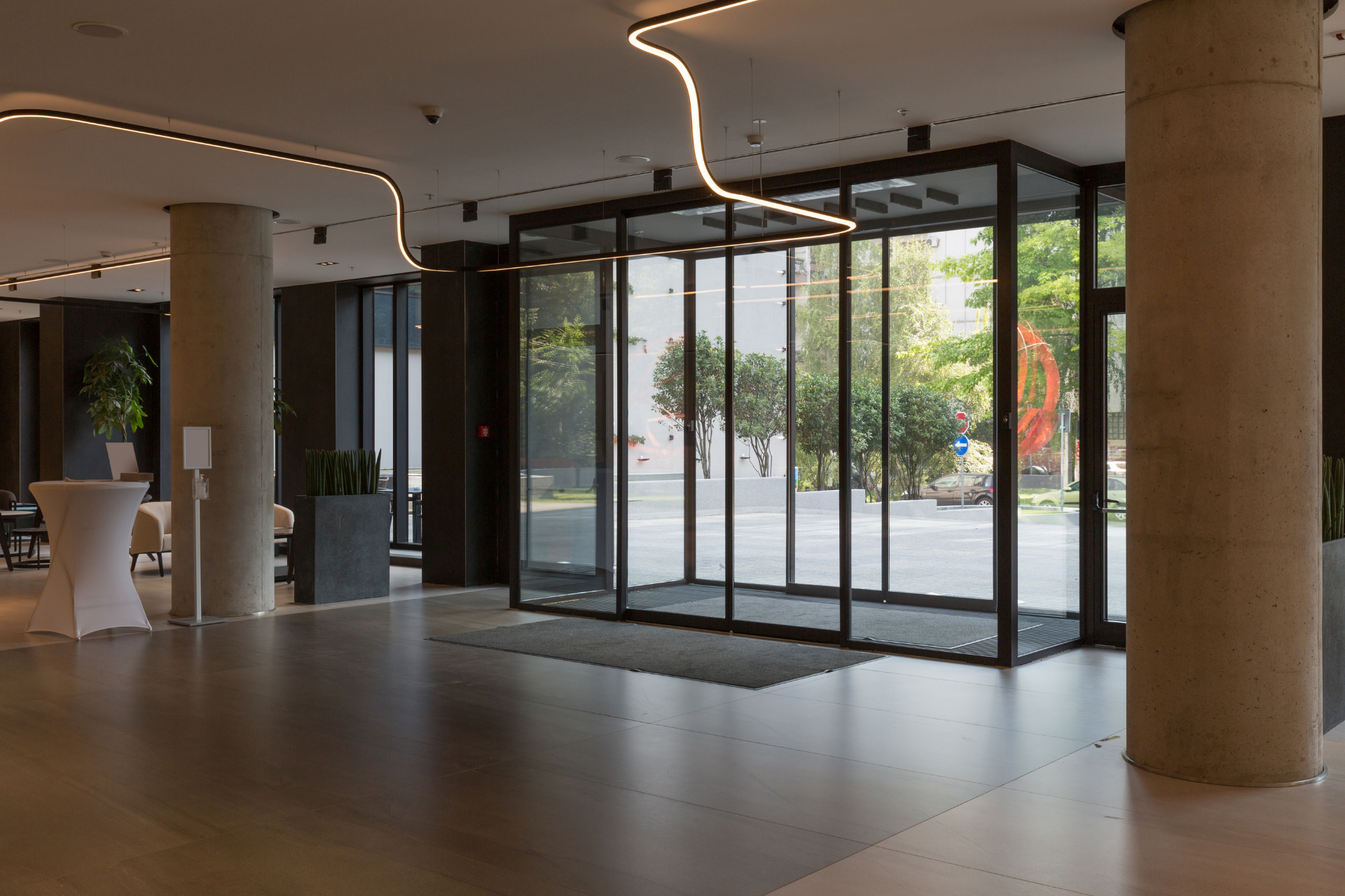 A large lobby with sliding glass doors and columns.