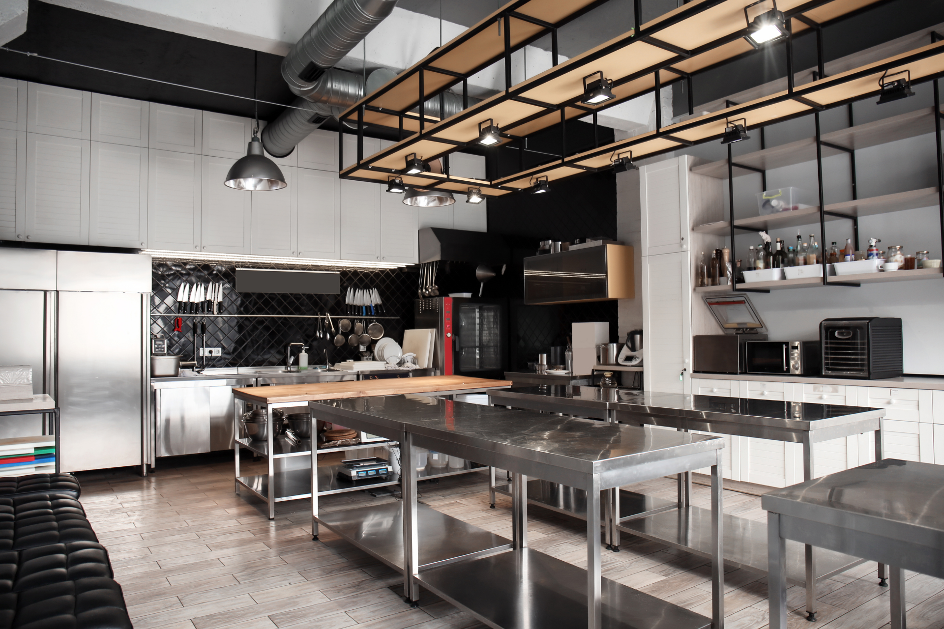 A large kitchen with a lot of stainless steel tables