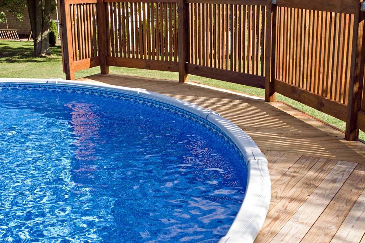 A swimming pool with a wooden fence around it
