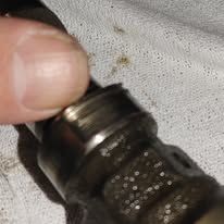 A person is holding a metal object with their finger.