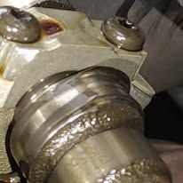 A close up of a metal object with a screw in it.