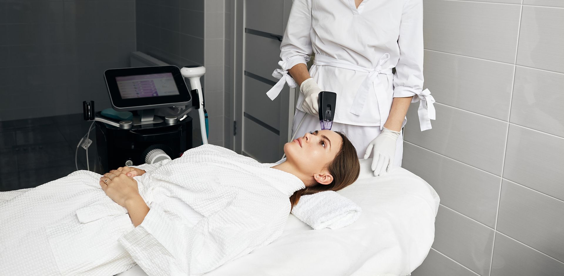 A woman is getting a microneedle treatment on her face.