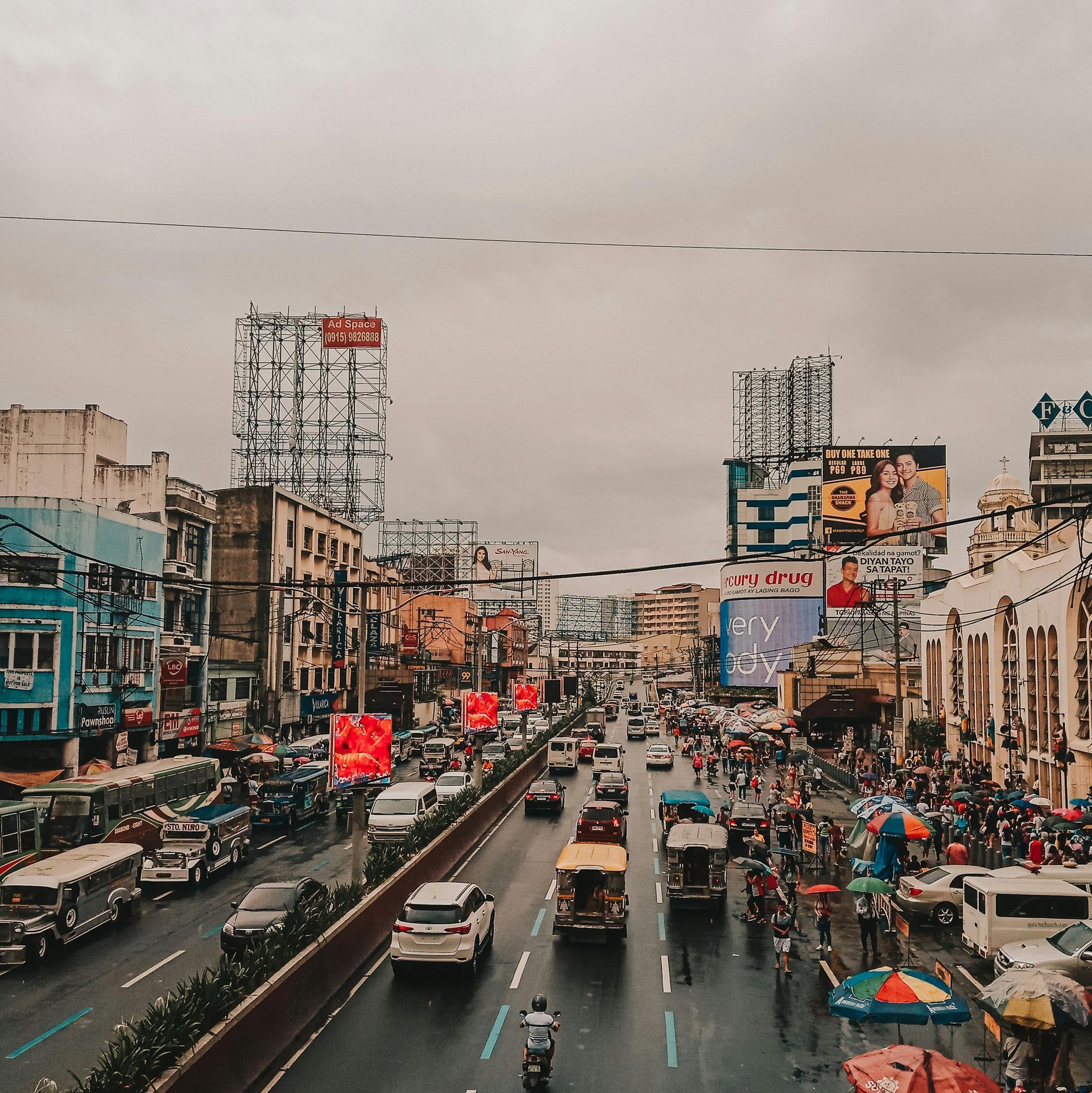 A busy city street with a lot of cars driving down it