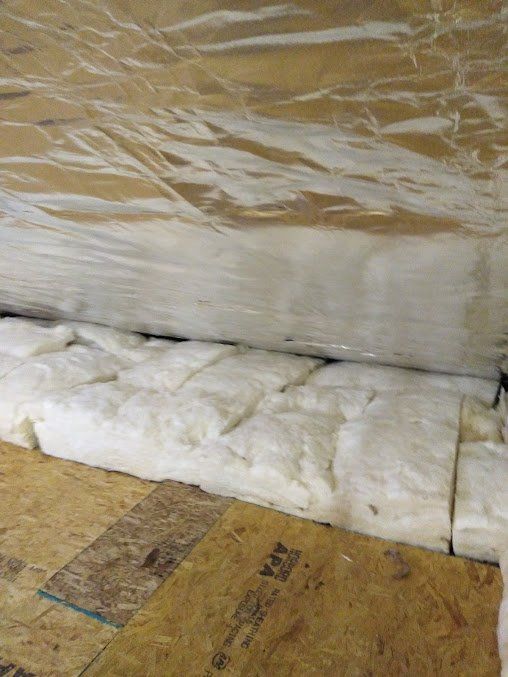 A pile of insulation is sitting on top of a wooden floor.