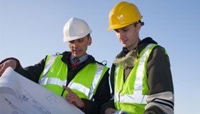 two men looking at a plan