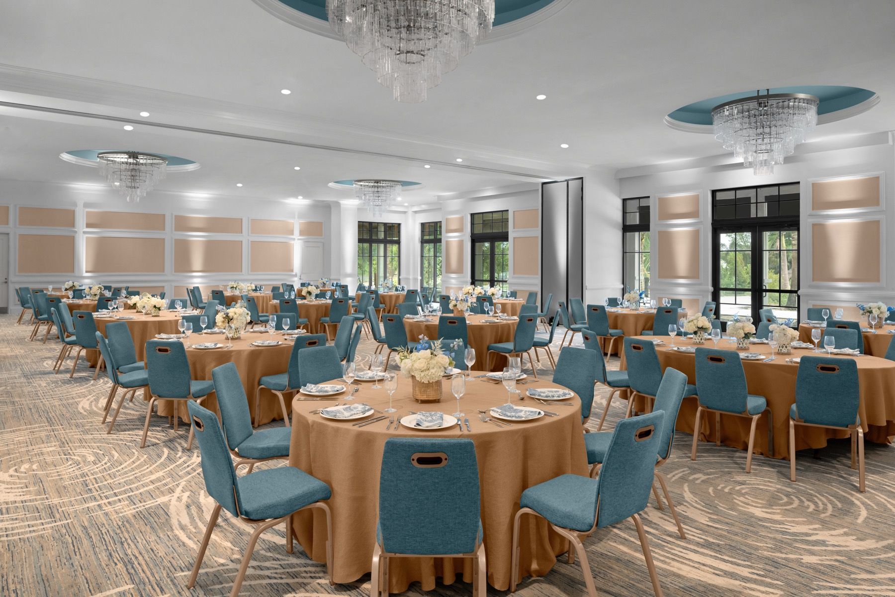 A large room with tables and chairs set up for a banquet.