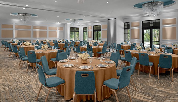 A large room with tables and chairs set up for a banquet.