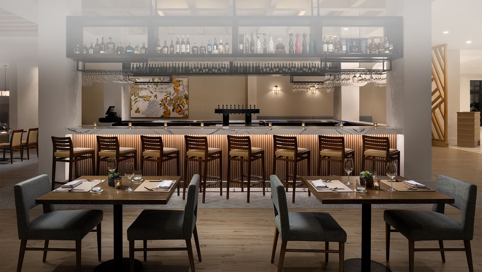 A restaurant with tables and chairs and a bar.