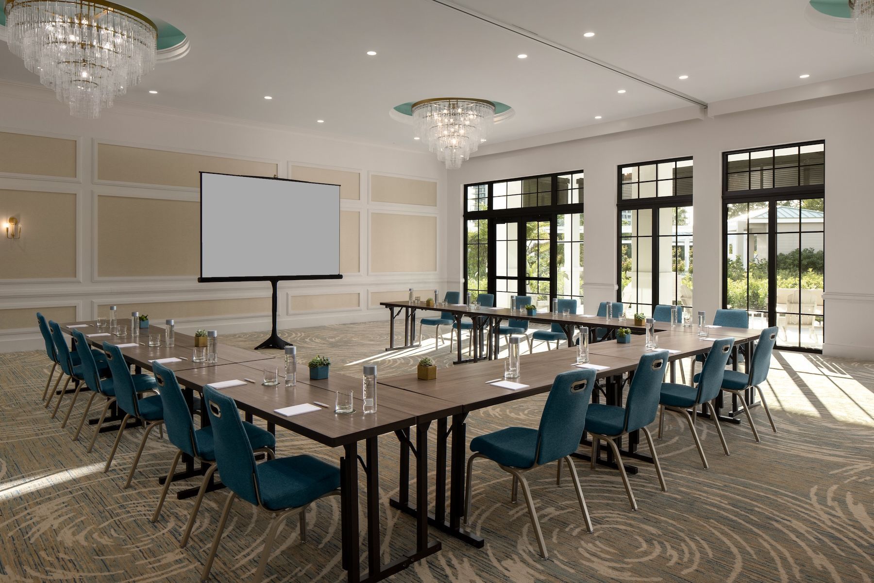 A large room with tables and chairs set up for a banquet.